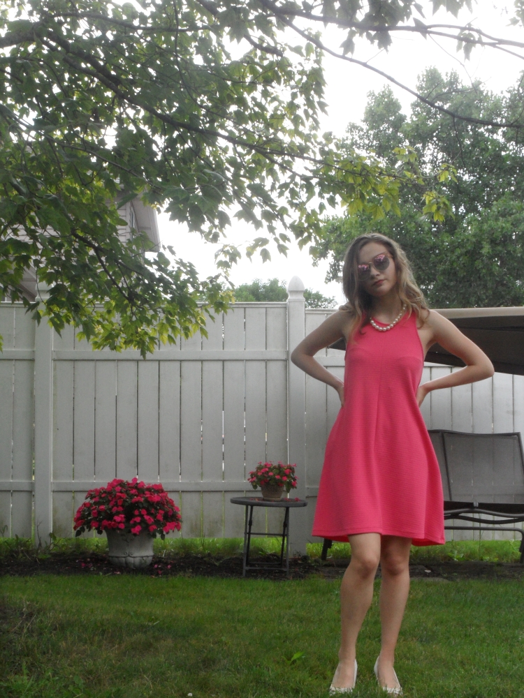 fashion blogger wearing pink dress and heels
