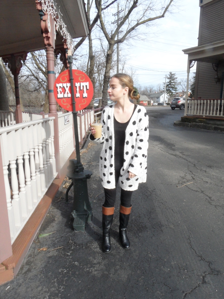 fashion blogger wears polka dot sweater, drinks coffee