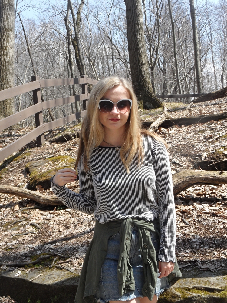 fashion blogger wears striped top, sunglasses